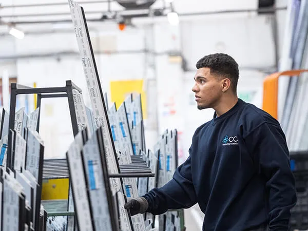 CO Manufacturing Staff Member holding UPVC Profile